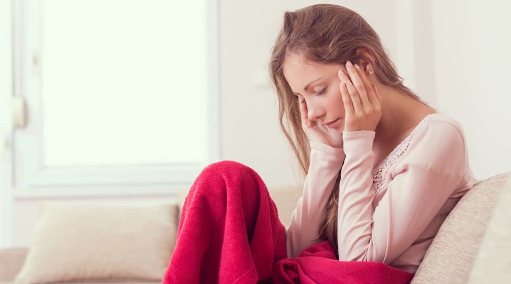 young woman feeling foggy and sad after head injury