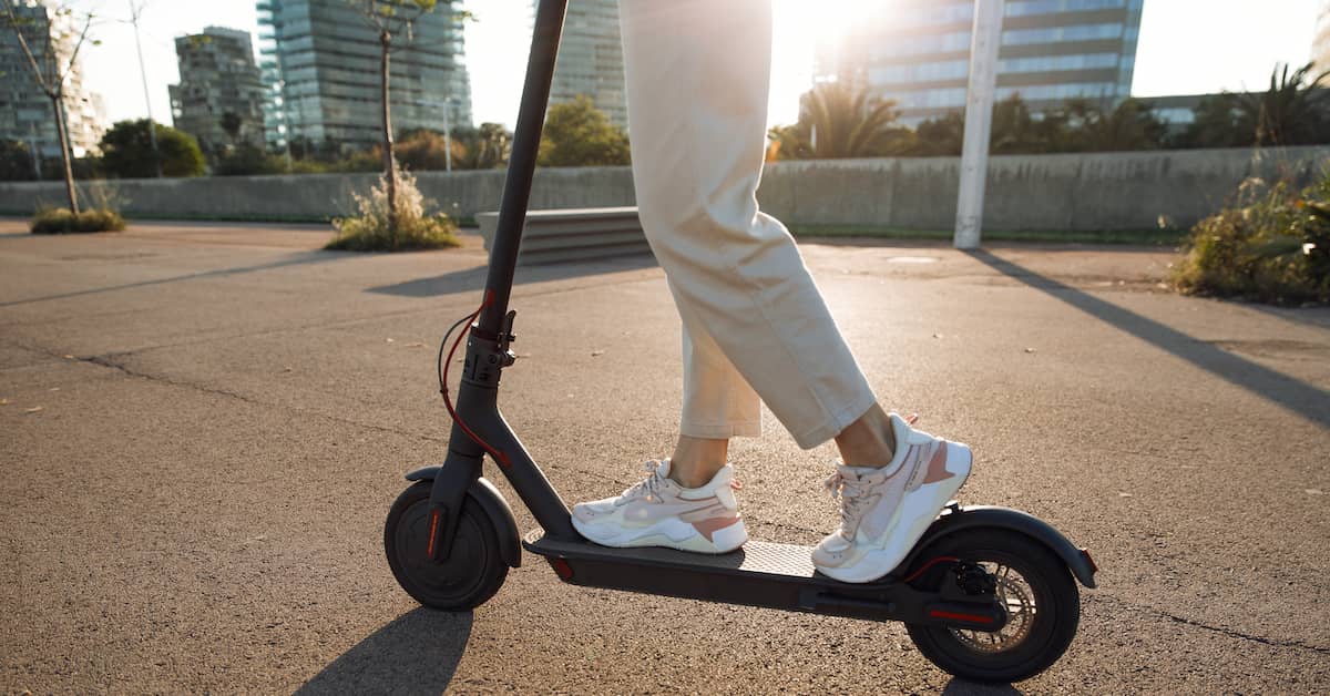 woman riding electric scooter