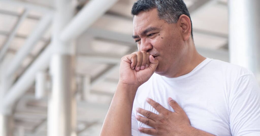 Coughing man struggling to catch his breath
