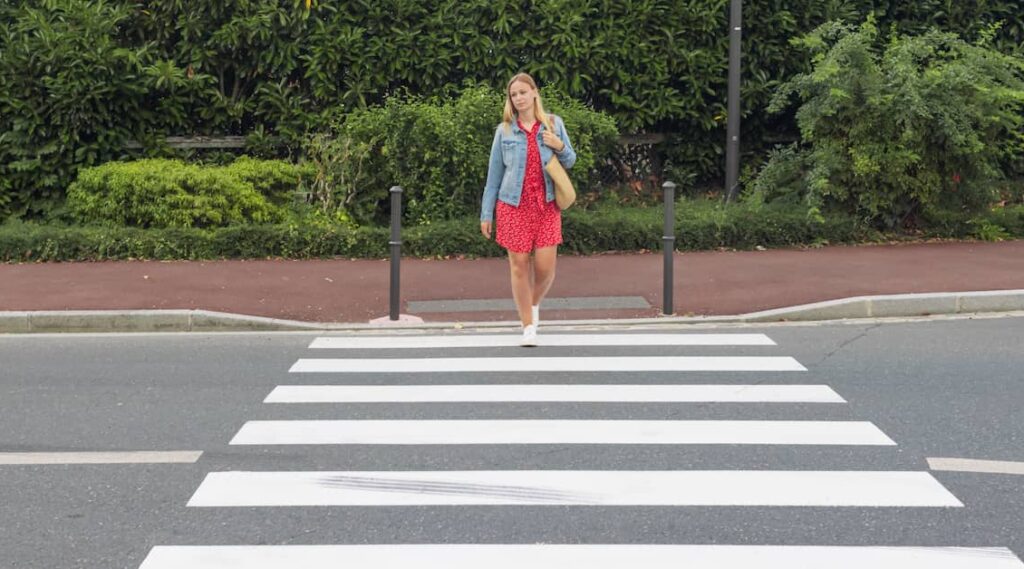 Woman entering a pedestrian crossing | Henry Carus + Associates