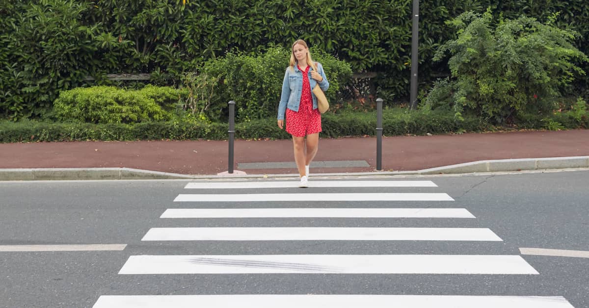 Woman entering a pedestrian crossing | Henry Carus + Associates