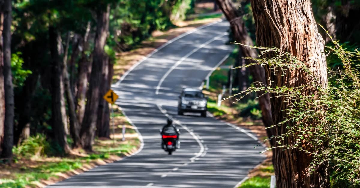 Motorbike travelling on a road outside Melbourne with another vehicle approaching | Henry Carus + Associates